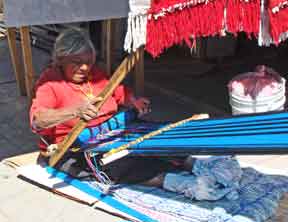 Woman weaving blanket material in Chapala